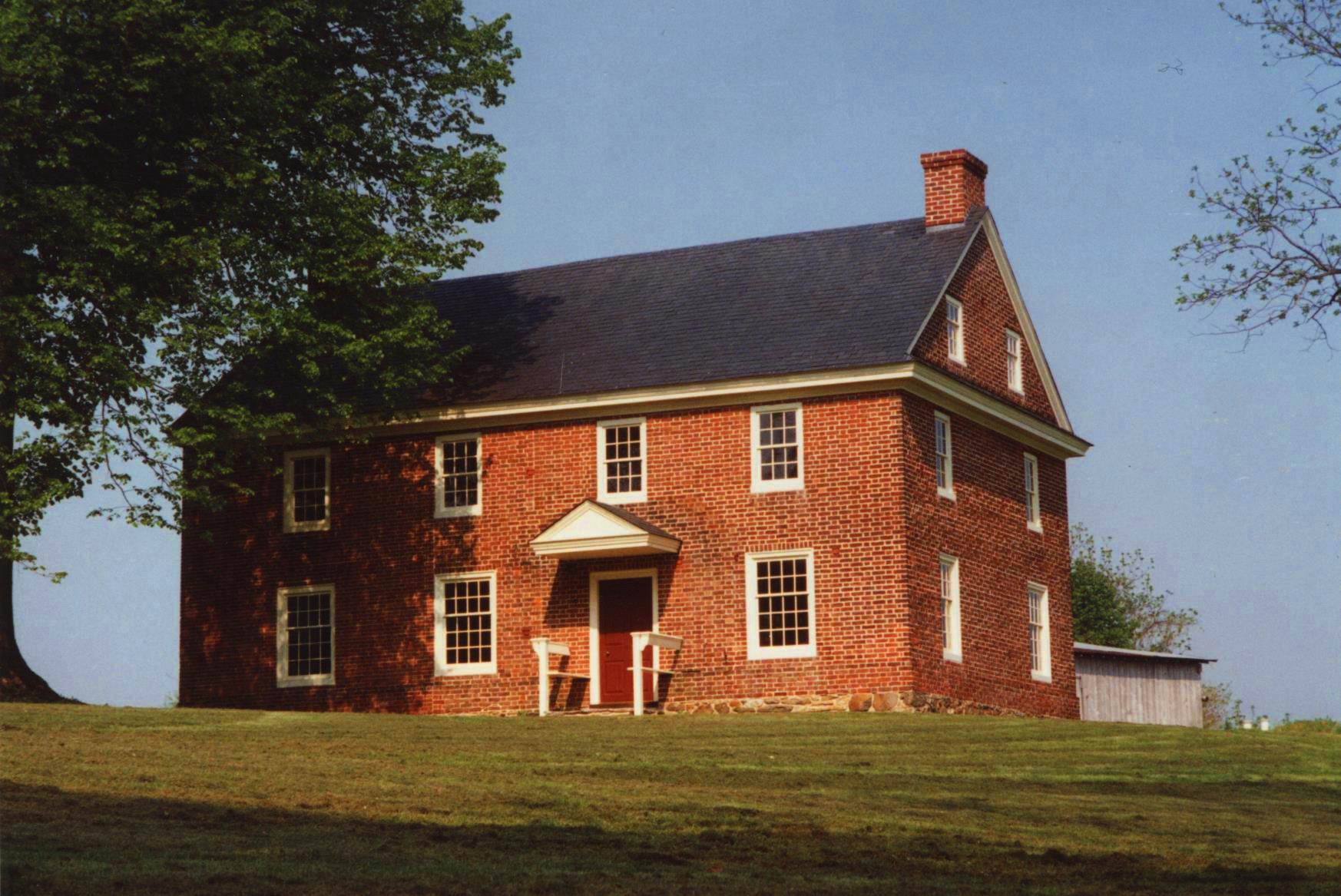 A fully restored brick home after historic preservation efforts.